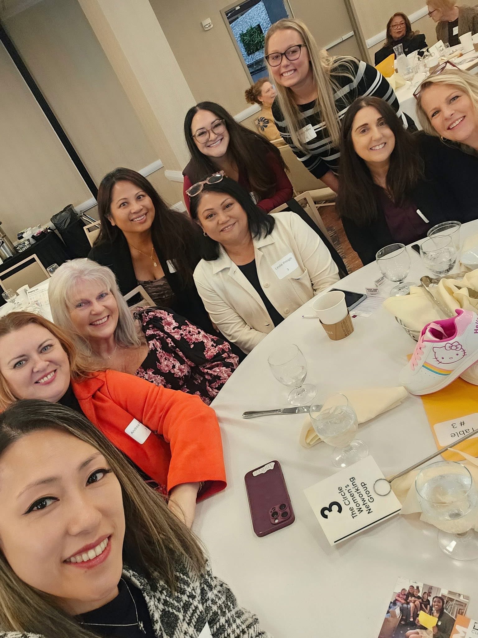 Women smiling around a table at a Circle gathering
